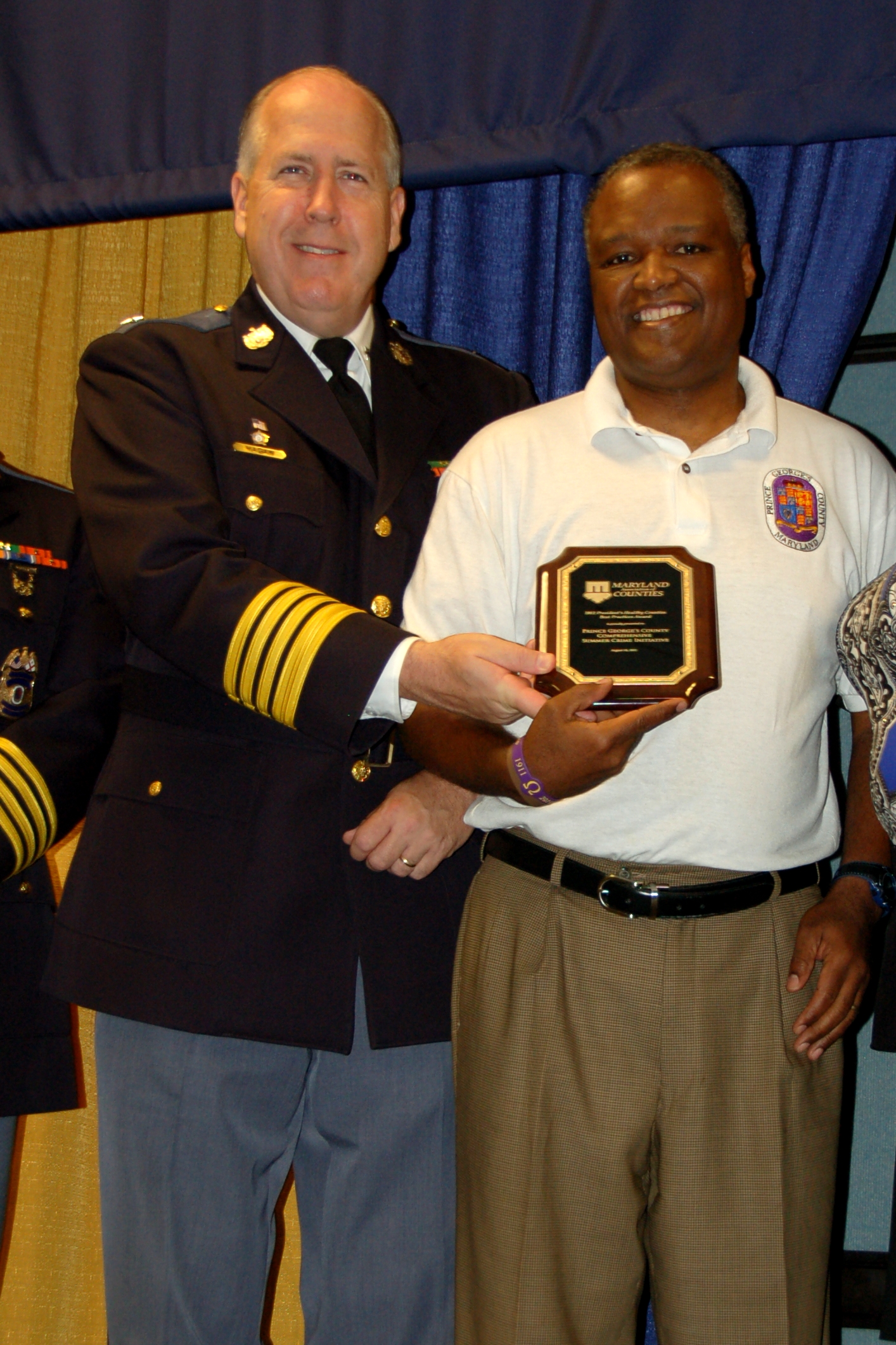 Two men holding award